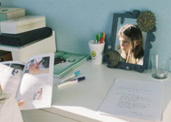 Young boy sitting at his desk reading